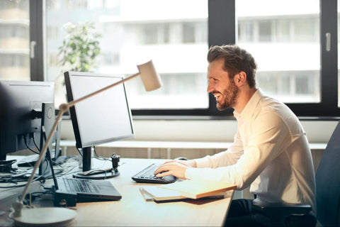 Man Smiling While Working in an Office Setting